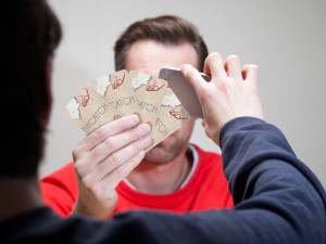 A Bycatch player surveilling an opponent's hand of cards